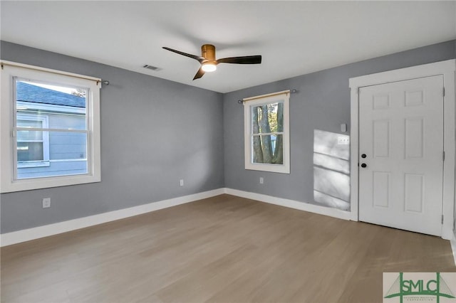 foyer with hardwood / wood-style floors and ceiling fan