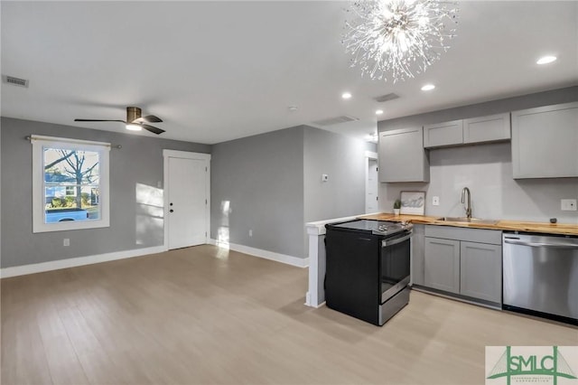 kitchen with gray cabinetry, sink, stainless steel dishwasher, and black range with electric cooktop