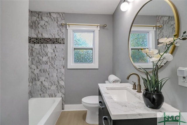 full bathroom featuring hardwood / wood-style floors, vanity, toilet, and a wealth of natural light