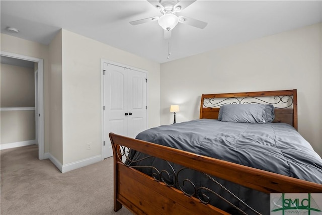 bedroom with ceiling fan, a closet, and light colored carpet