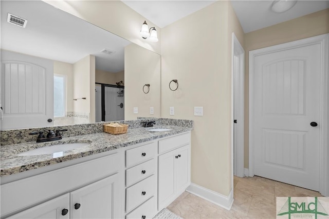 bathroom with tile patterned floors, vanity, and walk in shower