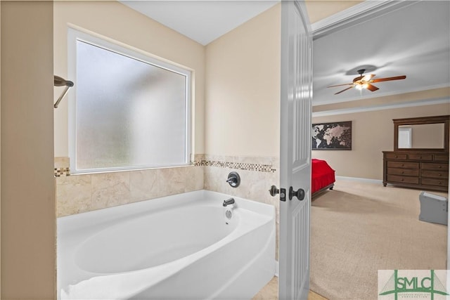 bathroom with plenty of natural light, a bath, and ornamental molding