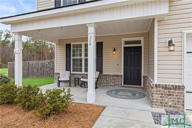 entrance to property featuring a porch