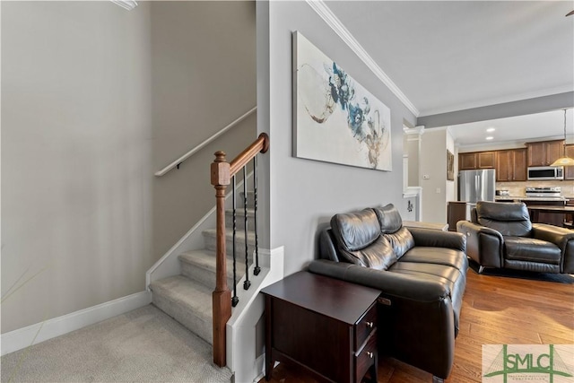 living room with hardwood / wood-style flooring and ornamental molding