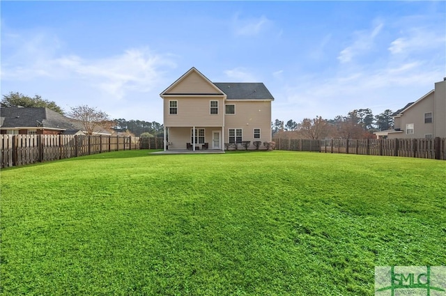 rear view of house with a yard and a patio