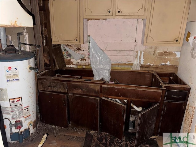 kitchen with cream cabinetry and water heater