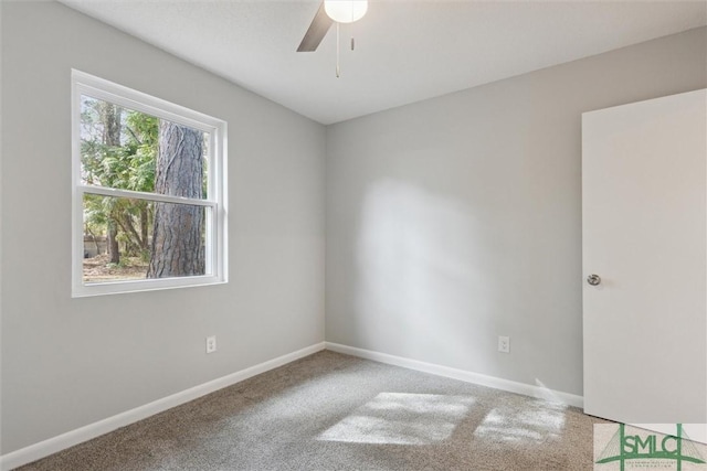 carpeted empty room featuring ceiling fan