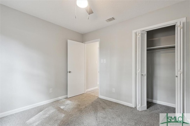 unfurnished bedroom featuring carpet flooring, a closet, and ceiling fan