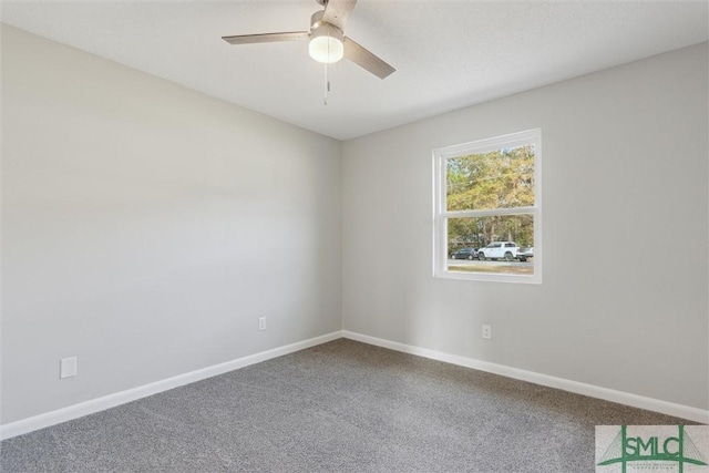 spare room featuring carpet and ceiling fan