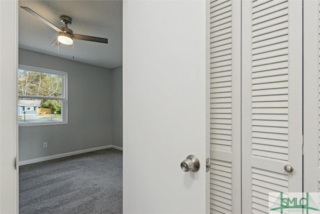 interior space with carpet and ceiling fan