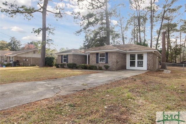 ranch-style home with a front lawn