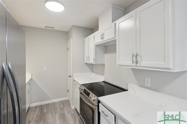 kitchen with appliances with stainless steel finishes, light wood-type flooring, and white cabinetry