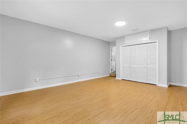 unfurnished bedroom featuring a closet and light hardwood / wood-style flooring