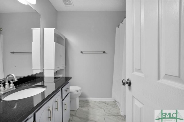 bathroom featuring vanity and toilet