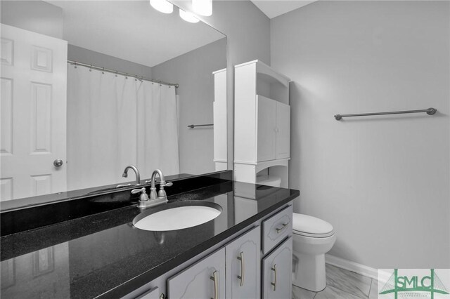 bathroom featuring vanity and toilet