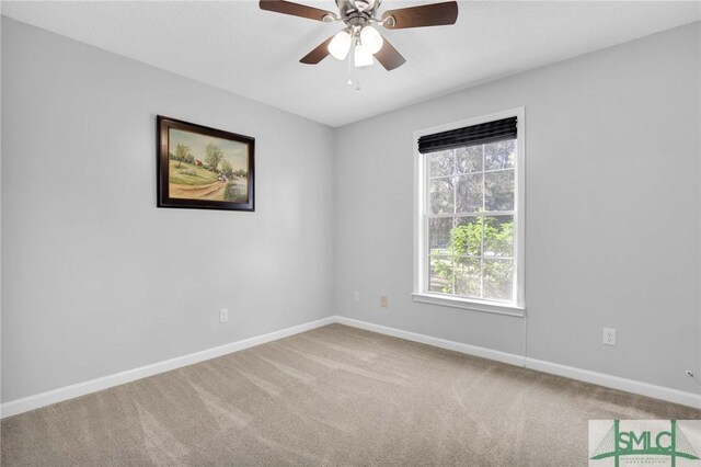 carpeted spare room with ceiling fan