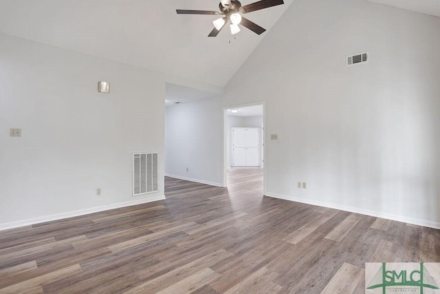 empty room featuring ceiling fan, wood-type flooring, and high vaulted ceiling