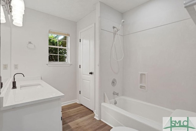 full bathroom with vanity, wood-type flooring, shower / bathtub combination, and toilet