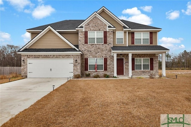 craftsman house with a front lawn and a garage