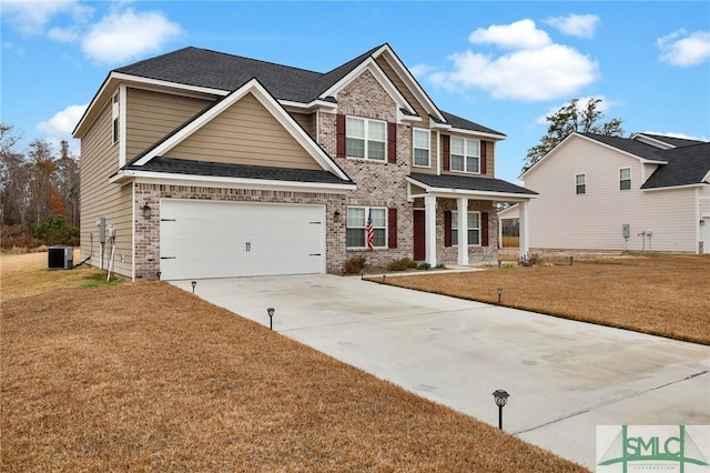 craftsman inspired home with a front lawn, cooling unit, and a garage