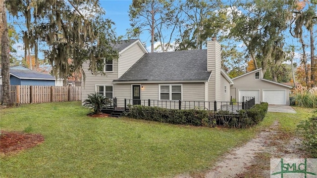 rear view of property with a lawn, a garage, an outdoor structure, and a deck