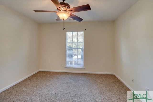 carpeted empty room featuring ceiling fan