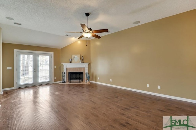 unfurnished living room featuring ceiling fan, french doors, wood-type flooring, a textured ceiling, and vaulted ceiling