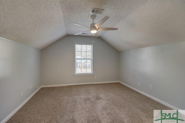 bonus room with a textured ceiling, carpet floors, ceiling fan, and lofted ceiling