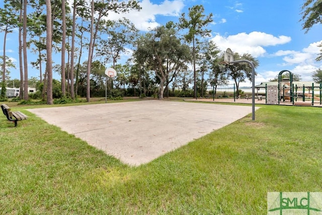 view of community featuring a playground, basketball hoop, and a lawn