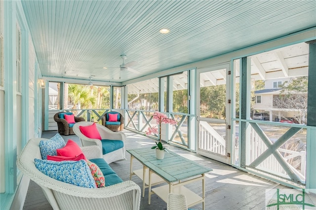 sunroom featuring ceiling fan and wood ceiling