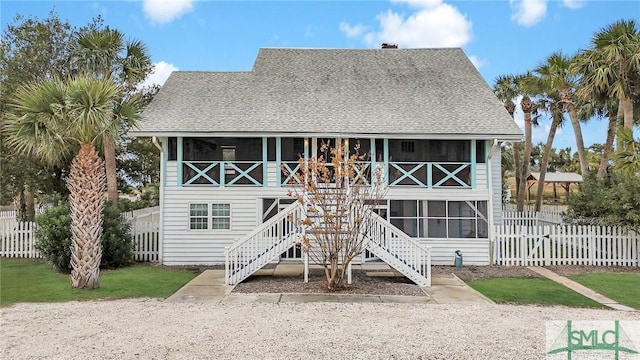 rear view of property with a sunroom