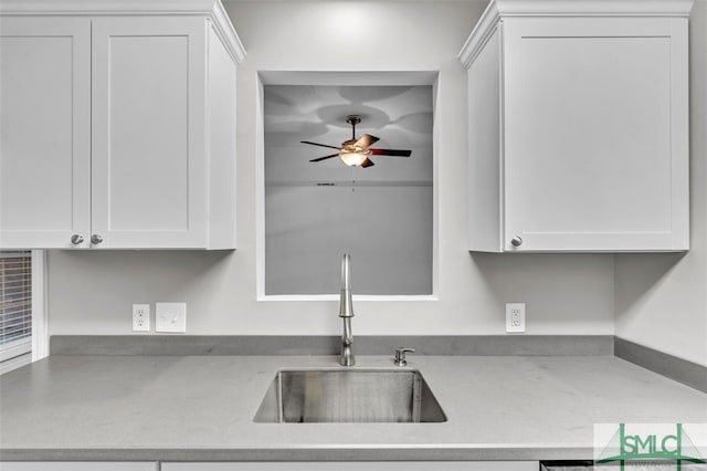 kitchen with white cabinetry, ceiling fan, and sink