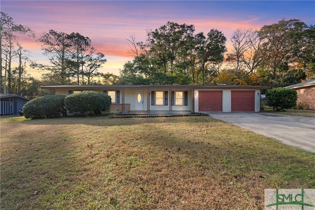 ranch-style home with a lawn and a garage