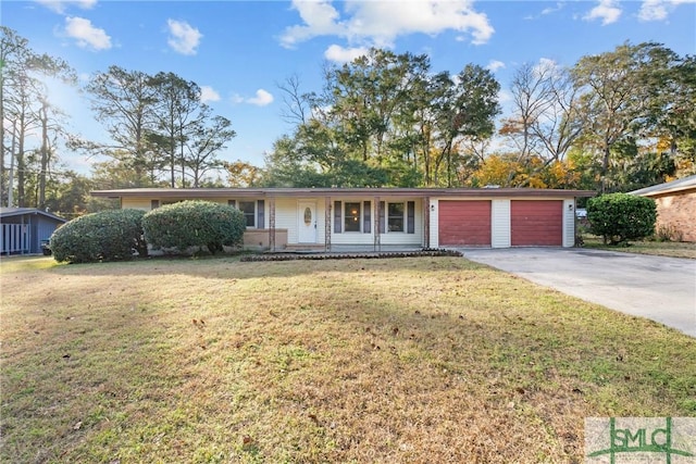 ranch-style home with a front yard and a garage