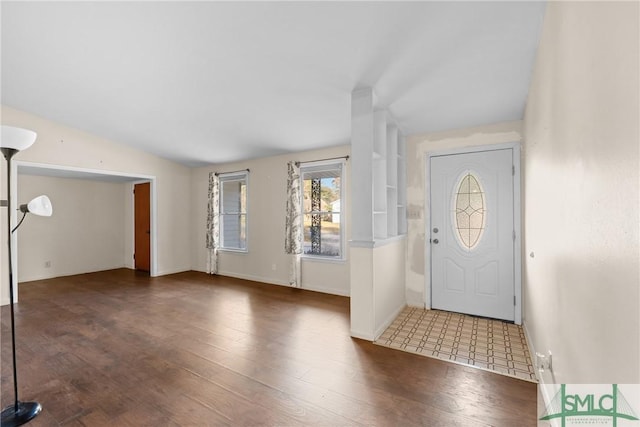 entrance foyer featuring hardwood / wood-style floors and vaulted ceiling