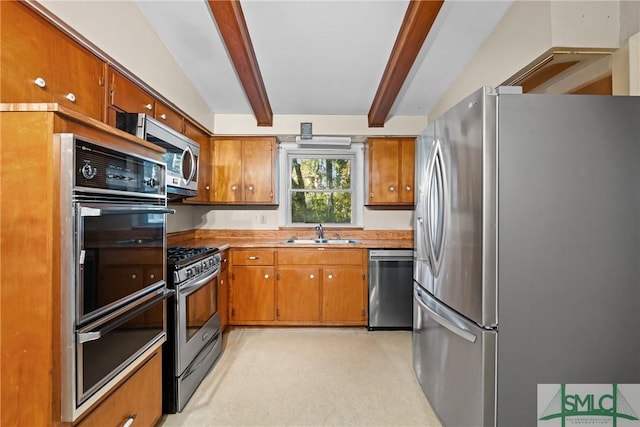 kitchen with vaulted ceiling with beams, light carpet, sink, and appliances with stainless steel finishes