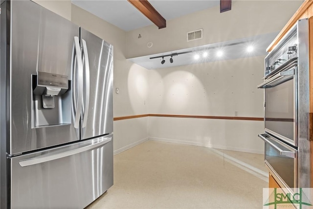 kitchen with rail lighting and stainless steel appliances