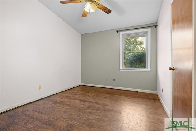 empty room featuring lofted ceiling, ceiling fan, and dark hardwood / wood-style floors