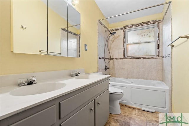 full bathroom with toilet, vanity, and tiled shower / bath