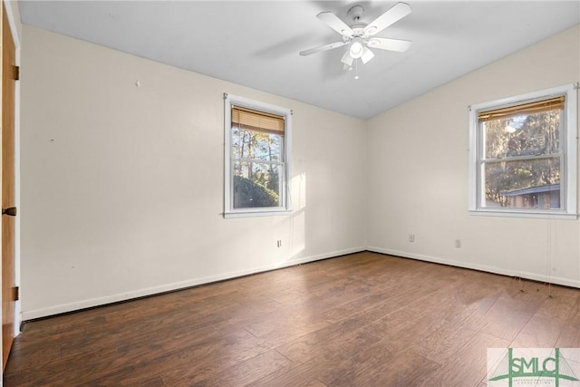 empty room featuring ceiling fan, lofted ceiling, and dark wood-type flooring