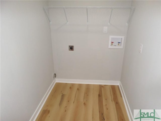 washroom with hookup for an electric dryer, hardwood / wood-style floors, and hookup for a washing machine