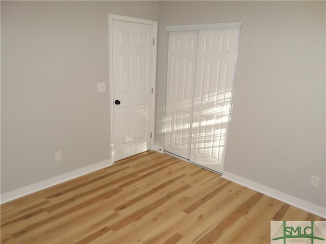 spare room with wood-type flooring