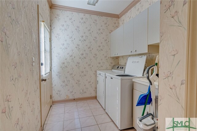 laundry room with washing machine and dryer, cabinets, a healthy amount of sunlight, and ornamental molding