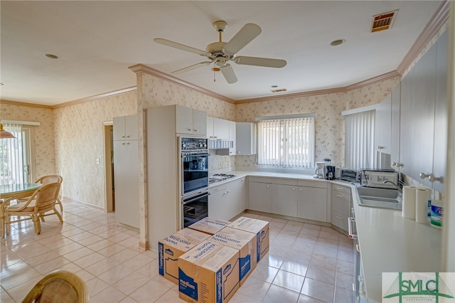 kitchen with ceiling fan, sink, stainless steel gas cooktop, black double oven, and ornamental molding