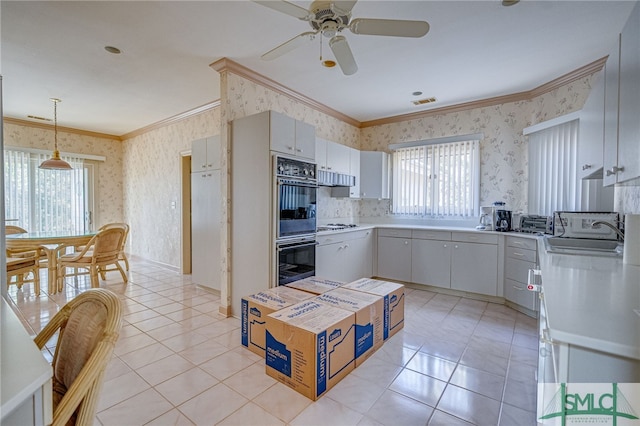 kitchen featuring decorative light fixtures, light tile patterned floors, sink, and double oven