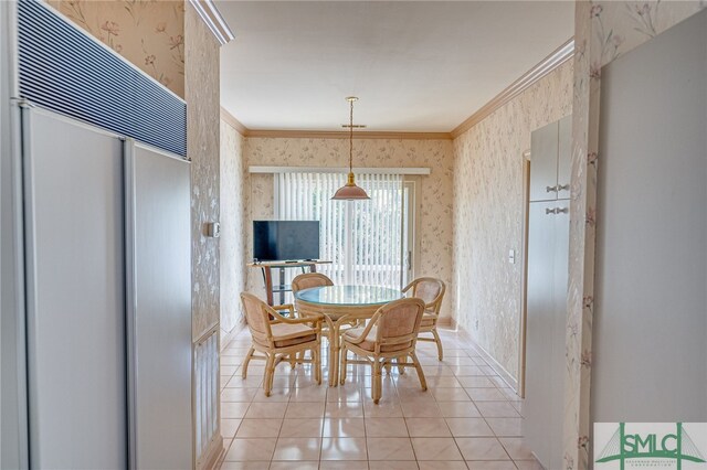 tiled dining area featuring crown molding