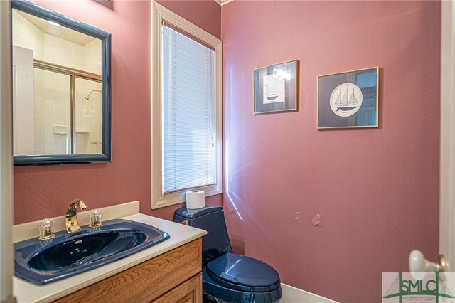 bathroom with vanity, toilet, and an enclosed shower