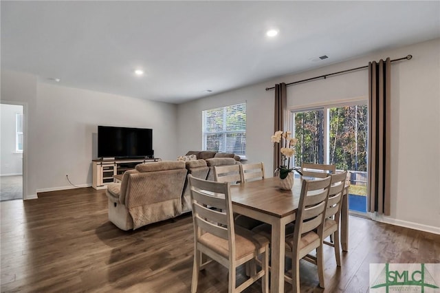 dining area featuring dark wood-type flooring