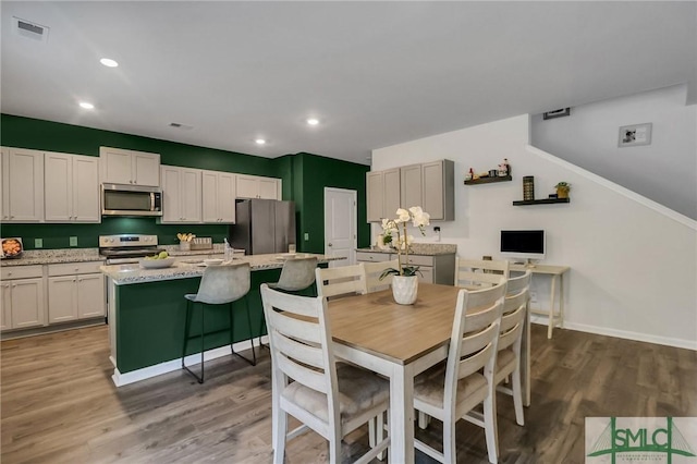 dining room with dark hardwood / wood-style flooring and sink