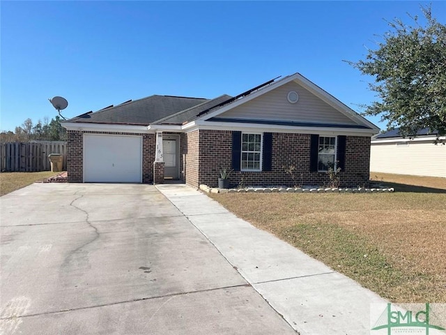 ranch-style home with a front yard, solar panels, and a garage